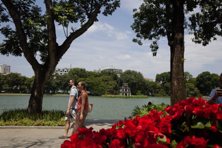 Tourists stroll around Ho Guom Lake