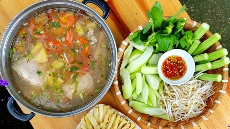 Sour fish soup, a flavorful Vietnamese dish, is made with a variety of fish, tamarind, and spices.