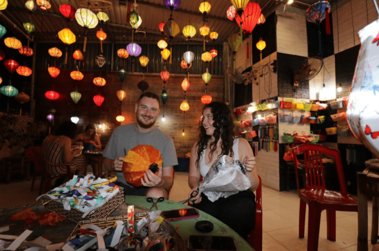 tourists making latterns in mid-autumn festival in vietnam