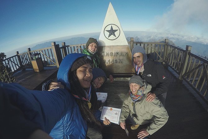 Trekkers conquering the peak of Fansipan