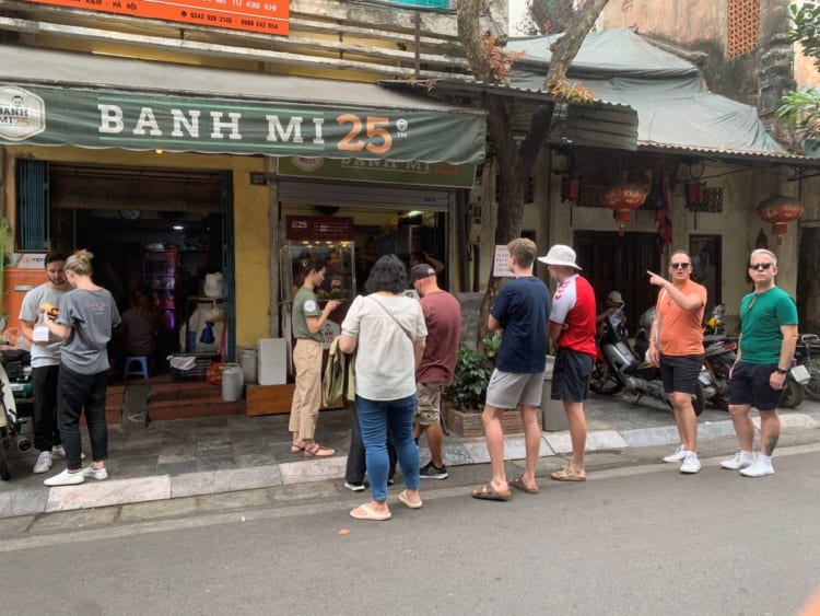 Foreign tourists queuing at Banh Mi 25