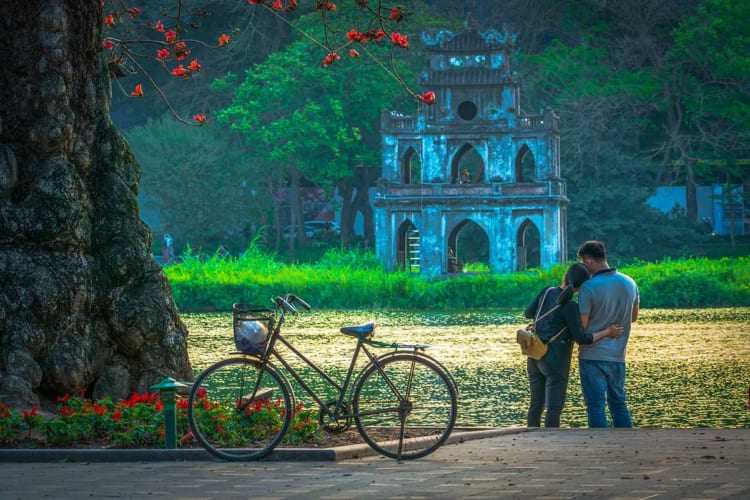 Romantic couple hugging at Hoan Kiem lake, Hanoi