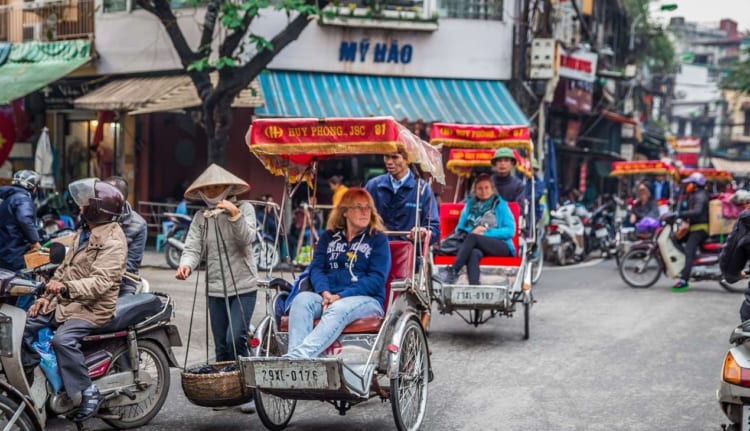 tourist on a cyclo tour in hanoi