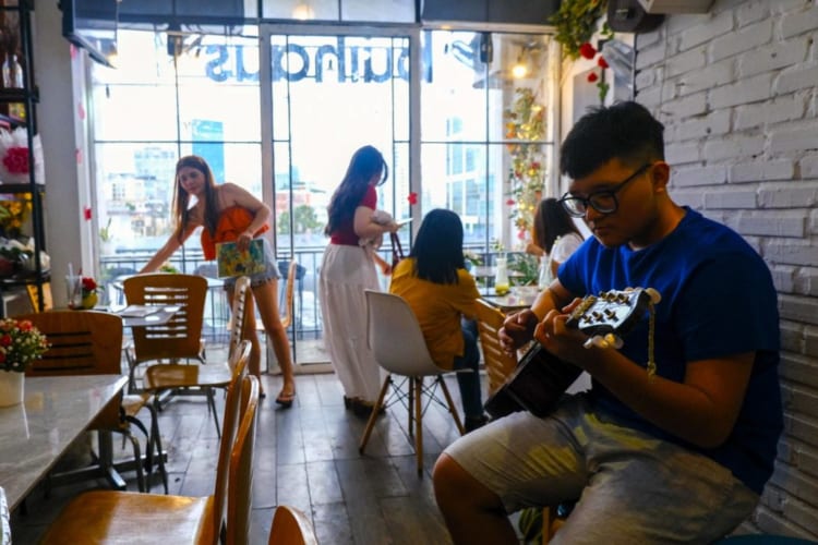 A boy playing guitar at Buihaus