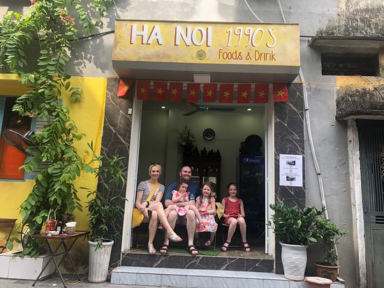 A tourist family at Hanoi 1990s Cafe.