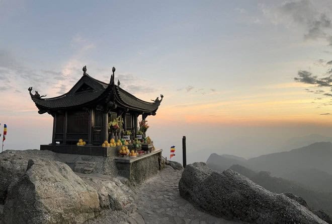 Small mountain temple with offerings at sunset, Vietnam sacred site, Lua Viet Tours destination.