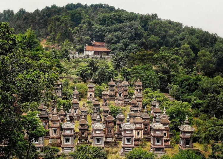Ancient Vietnamese pagodas and temples nestled in lush green forest mountains.