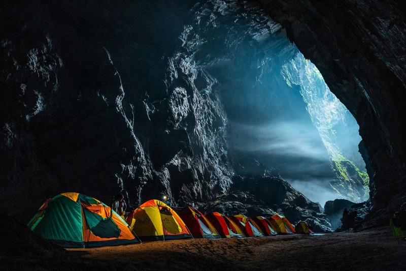 Campsite during a Son Doong cave trek beneath a natural skylight inside Son Doong Cave