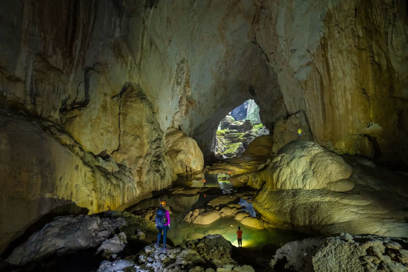 Trekker crossing rocky terrain illustrating Son Doong fitness requirements
