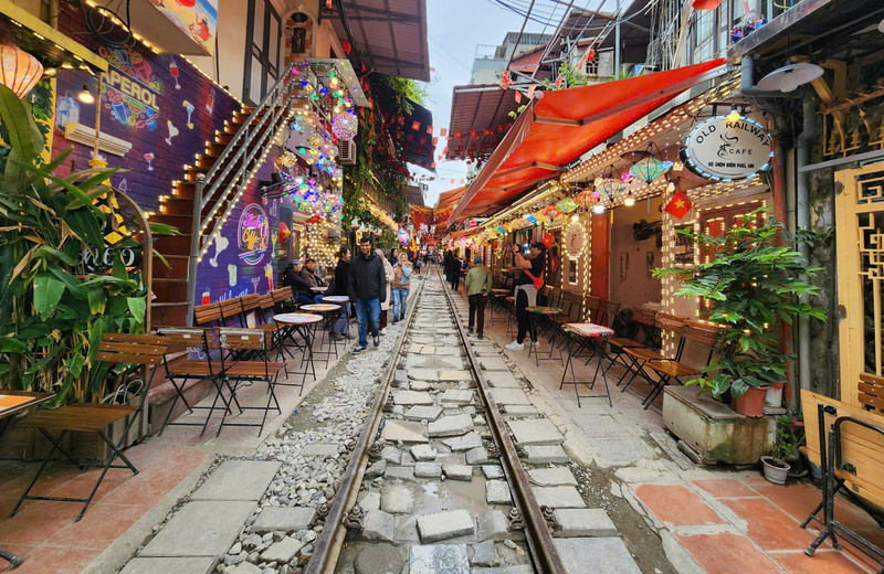 Local residents carrying out daily activities beside the Hanoi street train tracks