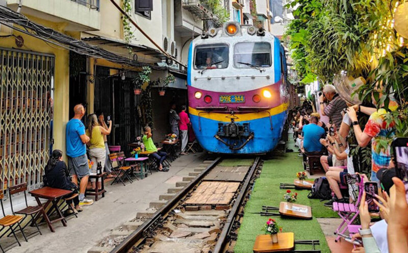 Overview of Hanoi Train Street Cafe with trackside seating and cafes along the railway