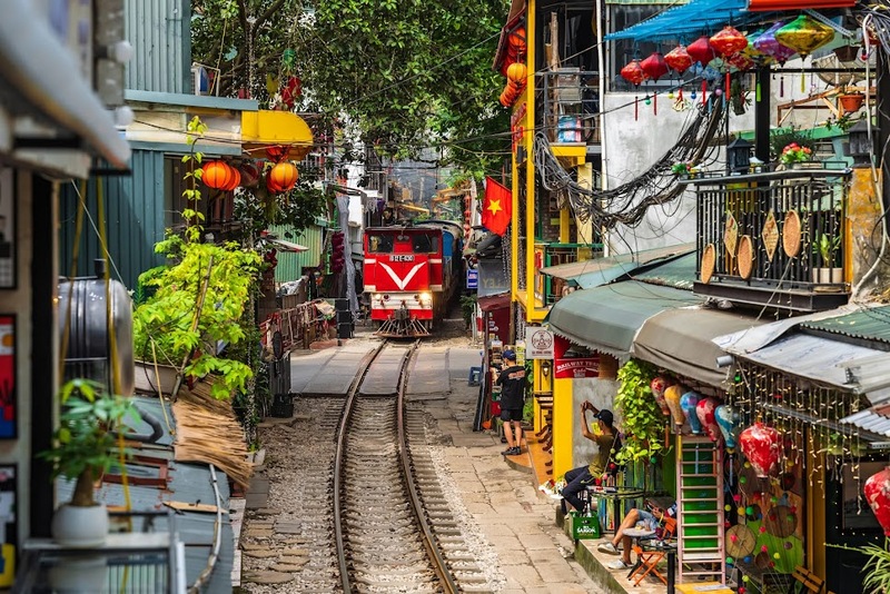 Hanoi Train Street with railway tracks running through a narrow residential alley in Hanoi