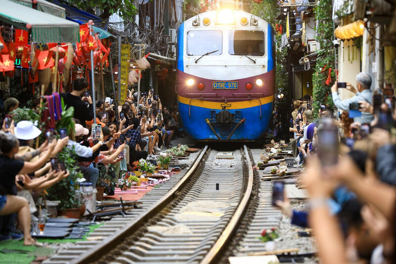 Wide view of Railroad Street Hanoi with train tracks and local neighborhood life